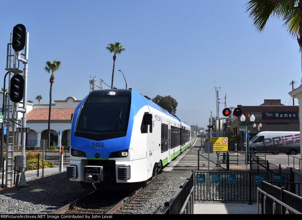 Metrolink Arrow Stadler DMU Car # 3404 crosses Orange Avenue at grade just as it arrives into Redlands Downtown Station 